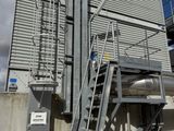 a metal staircase going up to the top of a building