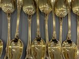 a lot of spoons that are hanging on the wall