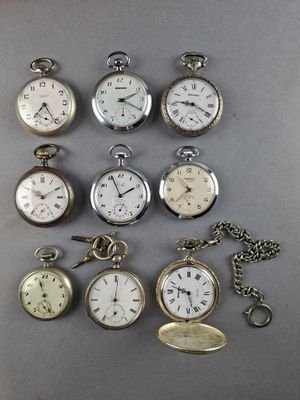 many different types of pocket watches on the table