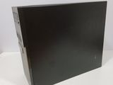 the back of a black computer case sitting on top of a white table