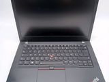 the laptop is open on a white surface with a black keyboard