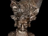 a close up of a statue of a woman wearing a hat