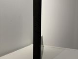 a close up of a black speaker on a white surface