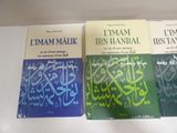 three books on a white table with arabic writing on them