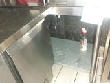 a stainless steel refrigerator in the corner of a kitchen