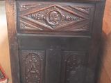 a wooden cabinet in a room with a rug on the floor