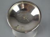 a close up of a silver object on a table