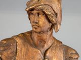 bronze statue of a man with a hat on his head