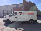 a white van that is parked in a parking lot