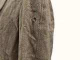 a close up of a man wearing a jacket and tie