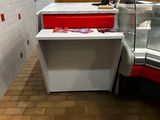 a counter with a red drawer and a white counter with a red drawer next to it