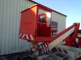 a red crane that is parked in front of a building