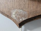 a close up of a wooden shelf with a clock on it