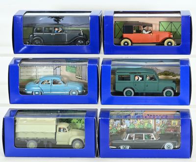 six toy cars are in a blue box on a white surface