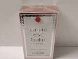 a close up of a box of perfume on a white surface
