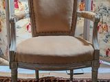 a chair that is sitting in front of a curtain