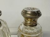 two salt and pepper shakers sitting on a tray