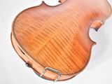a close up of a violin on a white surface