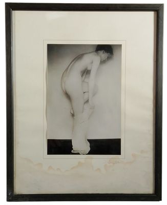a black and white photo of a naked man standing in front of a wall
