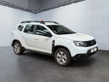 the white dacia suv is parked in a large room