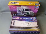 two boxed toy trucks sitting on top of each other on a table