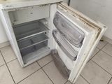 an old refrigerator that has been left open in the kitchen