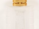 an image of a bottle of perfume sitting on a white surface