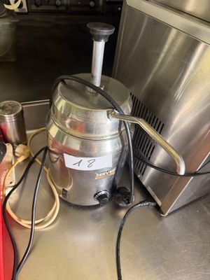 a silver machine sitting on a counter in a kitchen