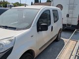 a white van parked in a parking lot next to other cars