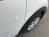 a close up of a white car with a sticker on it