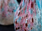 two glass vases that are sitting on a table