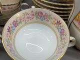 a lot of plates and cups that are on the table