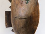 a wooden object that is hanging on the wall