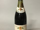 an old bottle of wine sitting on top of a table