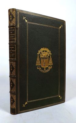 an old black book with a gold emblem on the cover