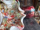 many different colored vases sitting on a table