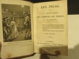 someone is holding an open book with a picture of a man on horseback