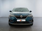 the front view of a blue car parked in a showroom