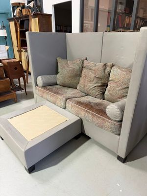 a couch and ottoman in the middle of a room