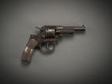 an old gun on a gray surface with a black background