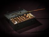 a black box with a wooden handle and some chocolates in it