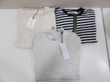 three men ' s t - shirts in a box with tags on them
