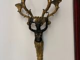a wall sconce with a deer head on it
