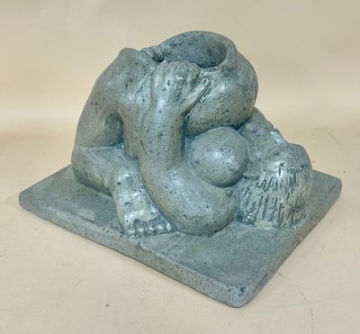 statue of a woman holding a baby in her arms on a stone base