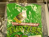 many bags of teenage mutant ninja shirts on the counter