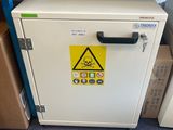 a white cabinet with a yellow hazard sign on it
