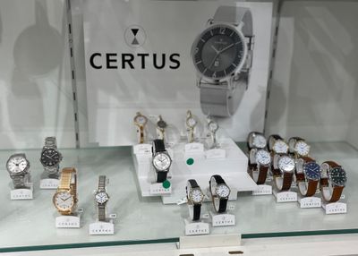 a lot of watches on display in a glass case