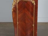 an antique wooden cabinet with a marble top and gold trimming