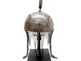 an old helmet with chainmails on a stand on a white background