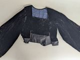 an image of a black jacket with a blue and black design